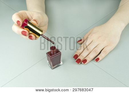 Stylish Fashionable Female Red Matte Manicure, Square Shape, On Black Background, Crocadile Skin