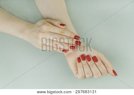 Stylish Fashionable Female Red Matte Manicure, Square Shape, On Black Background, Crocadile Skin