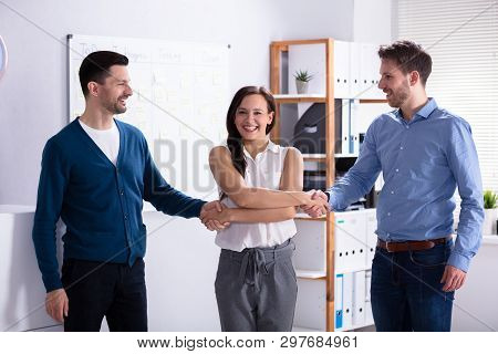 Woman Acting As Middleman In Deal Shaking Hands