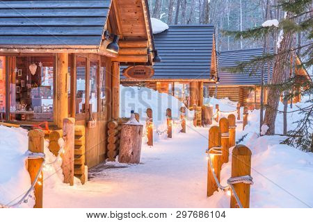 FURANO, JAPAN - FEBRUARY 15, 2017: Ningle Terrace at twilight. The collection of cottages situated in the woods are boutique shops specializing in handmade craft items.