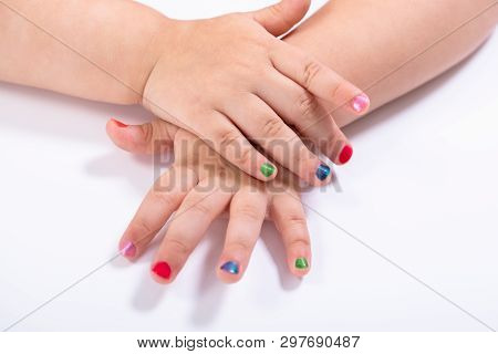 Close-up Small Girl Showing Colorful Nail Polish Against White Background