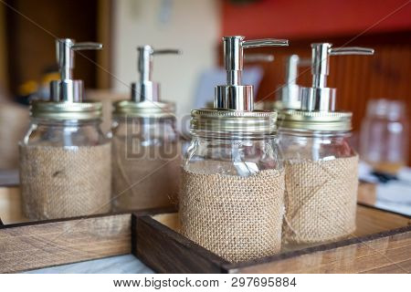 Set Of Glass Bottles With Pump Dispenser On A Tray
