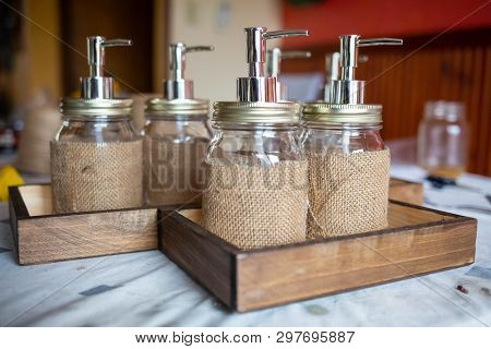 Set Of Glass Bottles With Pump Dispenser On A Tray