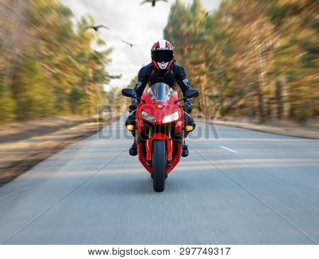 Krasnoyarsk, Russia - April 23, 2019: Beautiful Motorcyclist In Full Gear And Helmet On A Red And Bl