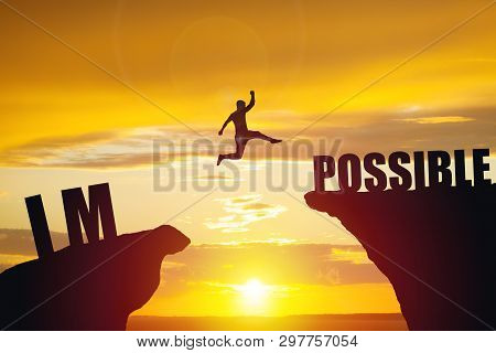 Man Jumping Over Impossible Or Possible Over Cliff On Sunset Background