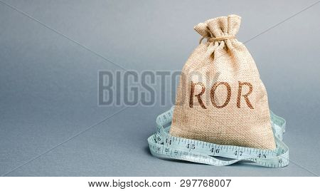 Money Bag With Measuring Tape And The Word Ror. Financial Ratio Illustrating The Level Of Business L