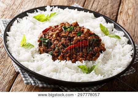 Thai Recipe For Basil Chicken With Chilli Pepper And Soy Sauce With Rice Garnish Close-up On A Plate