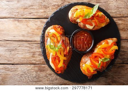 Spicy Cajun Fillet Chicken Baked With Cheese And Bell Pepper Close-up On A Board. Horizontal Top Vie