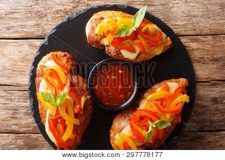 Cajun Chicken Baked With Cheese And Bell Peppers Close-up On A Serving Platter. Horizontal Top View