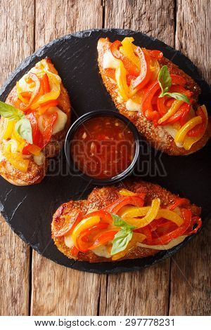 Delicious Cayenne Chicken Breast Baked With Cheese And Bell Peppers Closeup On A Board. Vertical Top