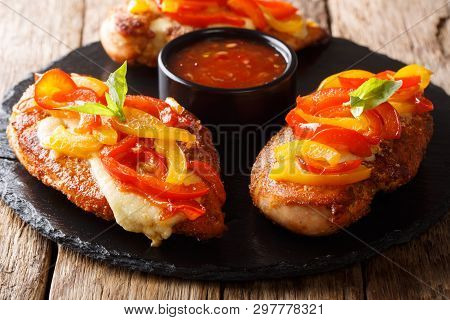 Delicious Cayenne Chicken Breast Baked With Cheese And Bell Peppers Closeup On A Board. Horizontal