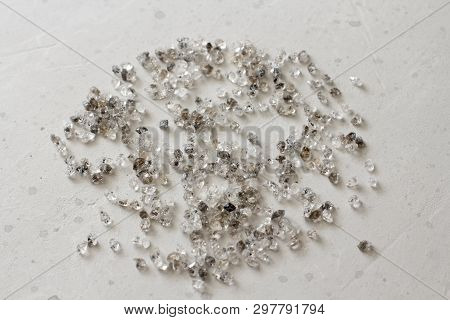 Scattered Diamonds On A Grey Background. Raw Diamonds And Mining, A Scattering Of Natural Diamond St