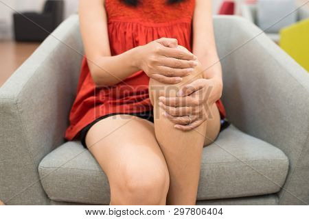 Woman Legs Pain With Hand Touching Her Knee And Sitting On Sofa At Home,disease Beriberi
