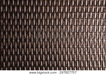 Close-up Dark Brown Background Is An Element Of Wicker Furniture Made Of Polymer Fibers. Synthetic L