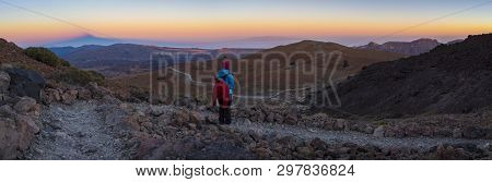 A Woman Hiking The Trail Up To The Peak Of The Teide Volcano On The Island Of Tenerife, Spain Is Wat