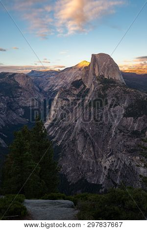 The Light Of The Sunset Shines Over The Half Dome In The Yosemite National Park.