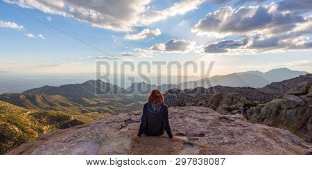 A Woman Staring Down From The Top Of Mount Lemmon In Arizona While The Sun Starts To Set.