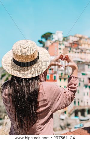 Happy Girl Making With Hands Heart Shape On The Old Coastal Village In Cinque Terre National Park. E