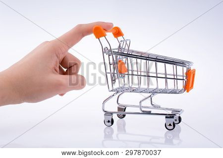 Hand Holding A Cart On A White Background