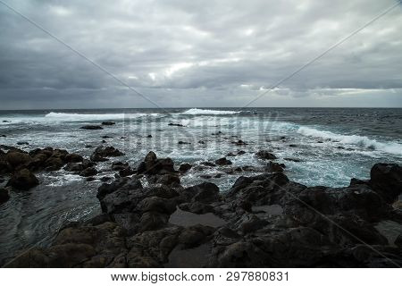 View From A Stony Shore To A Raging Ocean Wave During A Autumn Storm With A Horizon Line And Little 