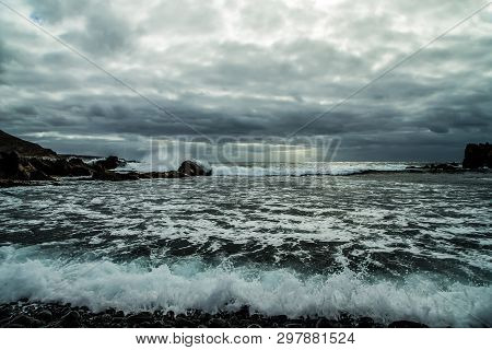 View From A Stony Shore To A Raging Ocean Wave During A Autumn Storm With A Horizon Line And Little 