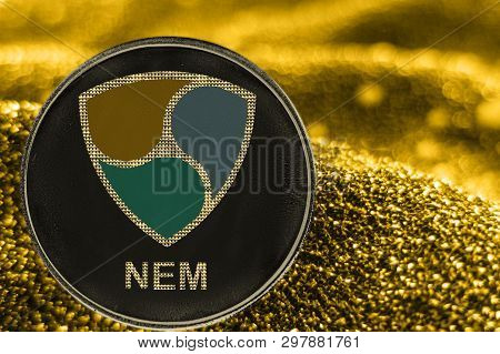Coin Cryptocurrency Nem And Gold Fabric Background. Crypto Token Xem.