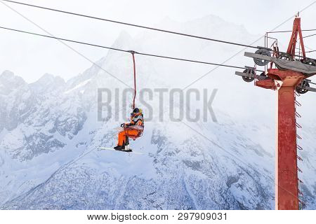 Dombai, Russia - January 3, 2014: People Are Lifting On Open Lft High Up In Caucasus Mountains