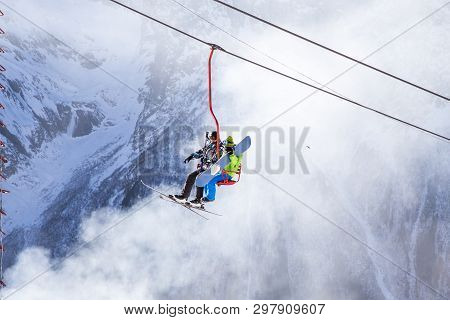 Dombai, Russia - January 3, 2014: People Are Lifting On Open Lft High Up In Caucasus Mountains