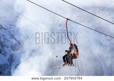 Dombai, Russia - January 3, 2014: People Are Lifting On Open Lft High Up In Caucasus Mountains