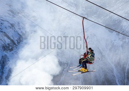 Dombai, Russia - January 3, 2014: People Are Lifting On Open Lft High Up In Caucasus Mountains