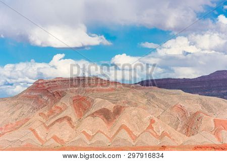 Interesting background of red banded strata viewed from Highway 163. The zigzag pattern is result of erosion of the tilted strata. Mexican Hat, Utah - USA. 