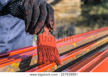 Worker Painter Covers Protective Paint Metal Structures. Protective Coating Of Steel Closed Profiles