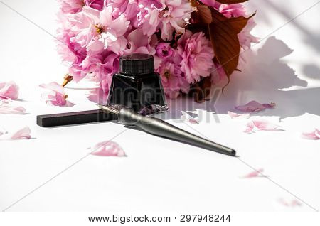 Old Ink Pen And Ink Bottle On White Background. Vintage Calligraphy Pen And Bottle Of Ink. Selective