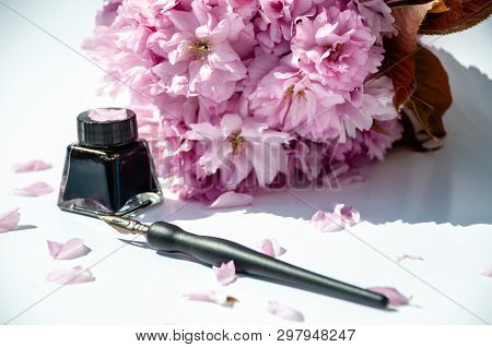 Old Ink Pen And Ink Bottle On White Background. Vintage Calligraphy Pen And Bottle Of Ink. Selective