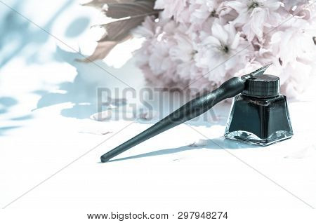 Old Ink Pen And Ink Bottle On White Background. Vintage Calligraphy Pen And Bottle Of Ink. Selective