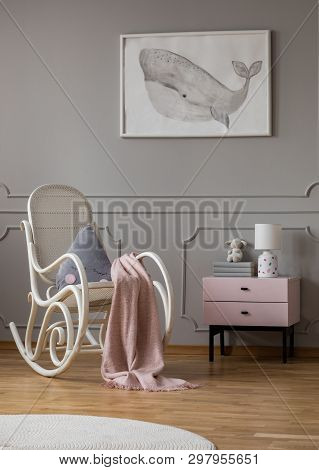 Whale On Poster In Fashionable Baby Room With White Rocking Chair And Pastel Pink Nightstand With Bo