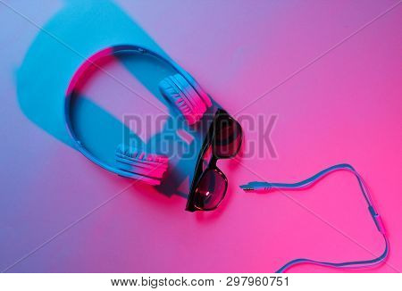 Sunglasses With Headphones. Retro Wave, Blue Pink Neon Light, Ultraviolet. Top View, Minimalism