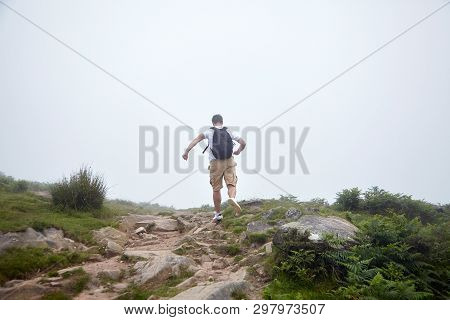 Man Runing On The Top Of Hill On Foggy Summer Day. Hiking Trail In The Pyrenees. La Rhune Mountain, 