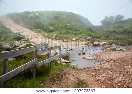 Hiking Trail, Stream, Wooden Fence And Tree In The Fog. Foggy Summer Day. La Rhune Mountain, Basque 
