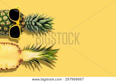 Fresh Pineapples With Sunglasses On Yellow Background. Creative Suumer Concept.