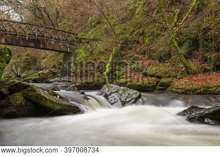 Long Exposure Of The East Lyn River Flowing Under A Bridge At Watersmeet In Exmoor National Park In 