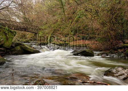 Long Exposure Of The East Lyn River Flowing Under A Bridge At Watersmeet In Exmoor National Park In 