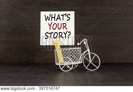 Wooden Clothespin With White Sheet Of Paper. Text 'what Is Your Story'. Miniature Bicycle Model. Bea
