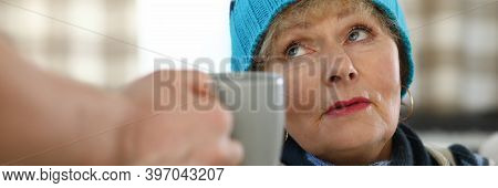 Sad Elderly Woman At Home Takes Cup With Hot Drink. Son Brought Cup Tea For An Elderly Mother. Son T