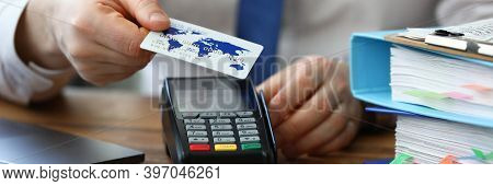 Office Employee Shows Credit Card And Terminal. Banking Application. Pos-terminal Communications Are