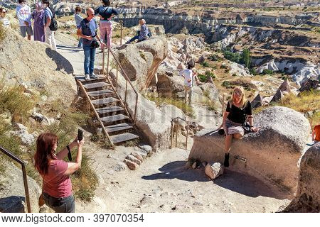 Uchisar, Turkey - October 4, 2020: These Are Unidentified People At The Top Of The Rock Of The Uchis