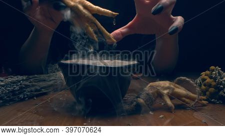 Closeup, Detailed. Hands Of A Witch With Black Nails Above A Bowl Of Thick Smoke