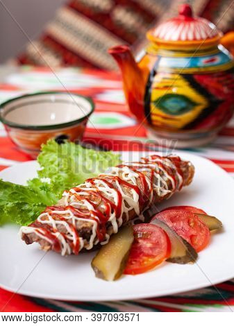 Brizol - A Dish Of Omelet And Beef Covered With Ketchup And Mayonnaise In An Oriental Style