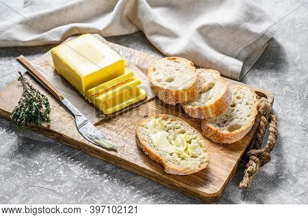 Farm Butter And Fresh Baguette With Butter. Gray Background.top View