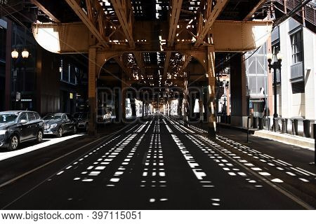 Sunlight Streaming In Underneath The Quincy Street Elevated Train Station Train Tracks In Chicago, O